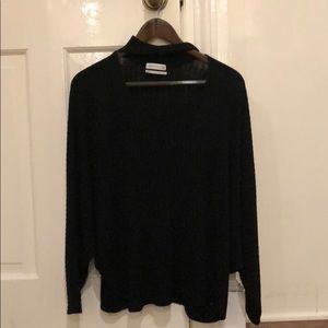 A black long sleeve shirt with a V-neck cutout
